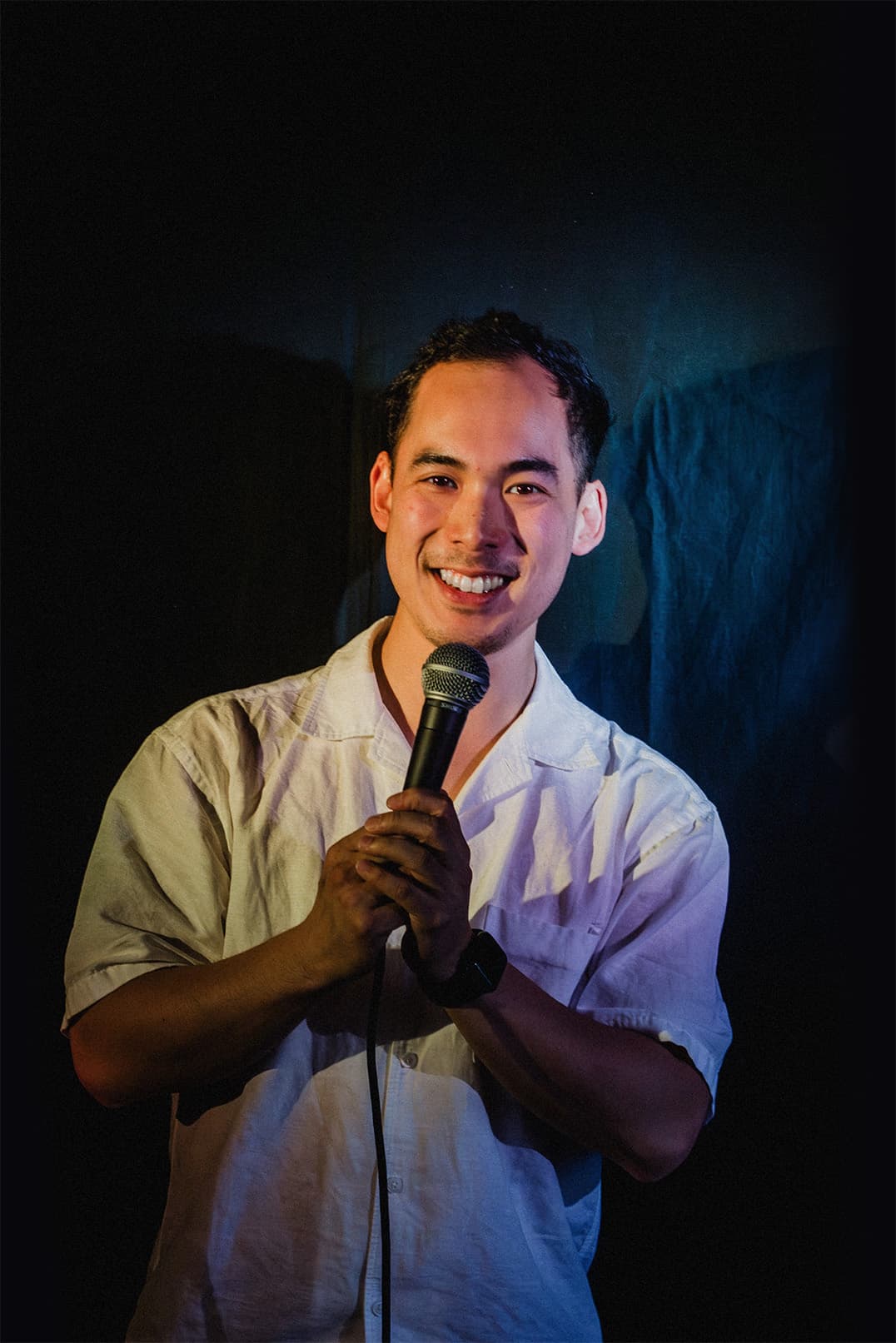Toto Nguyen performing live with a microphone